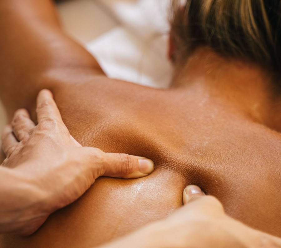 A woman enjoying a relaxing back massage in a spa setting, promoting wellness and relaxation.